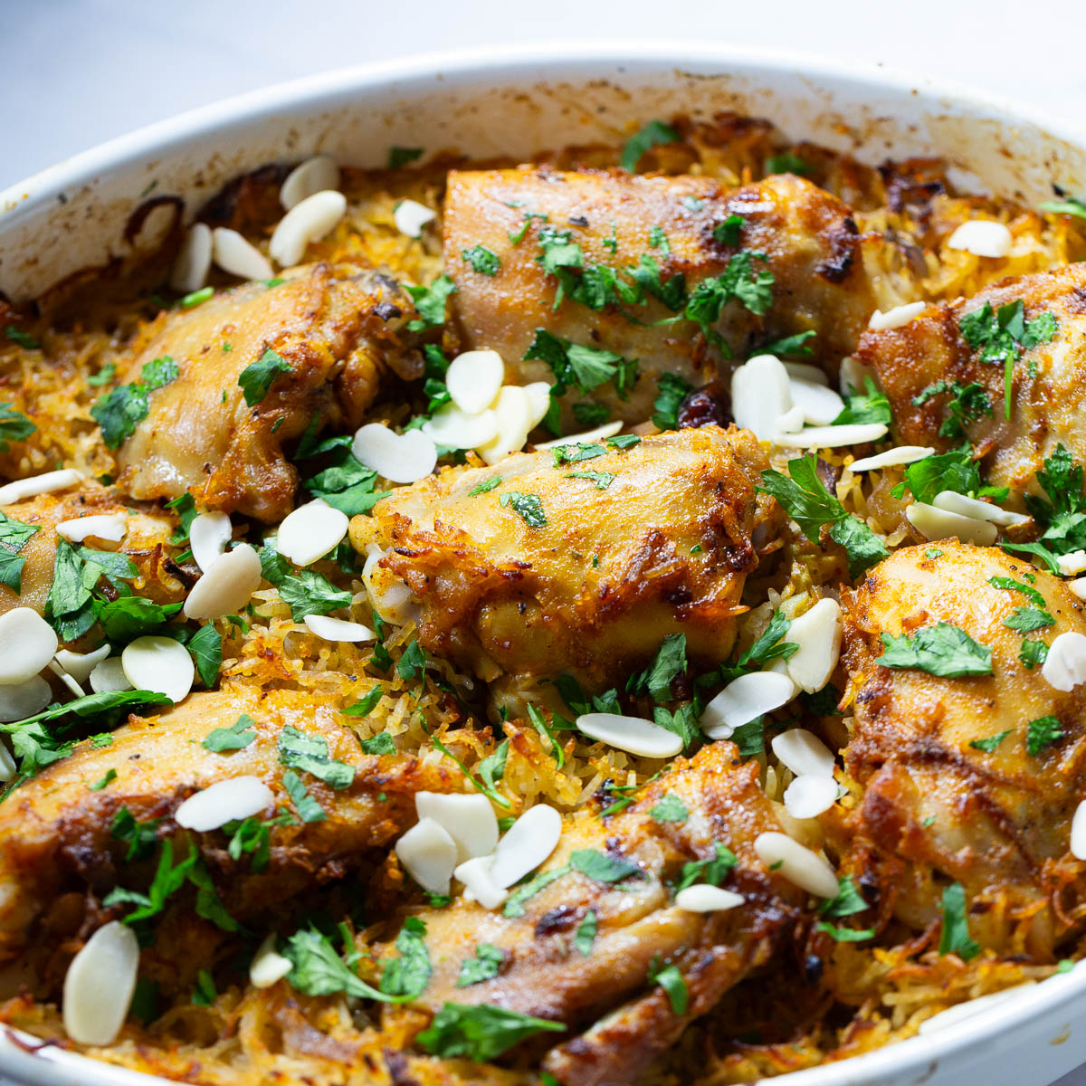 A baking dish with baked chicken and rice.