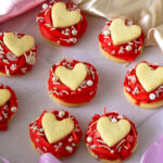 Buttercream Rose Frosted Cookies with Heart Cookies on top.