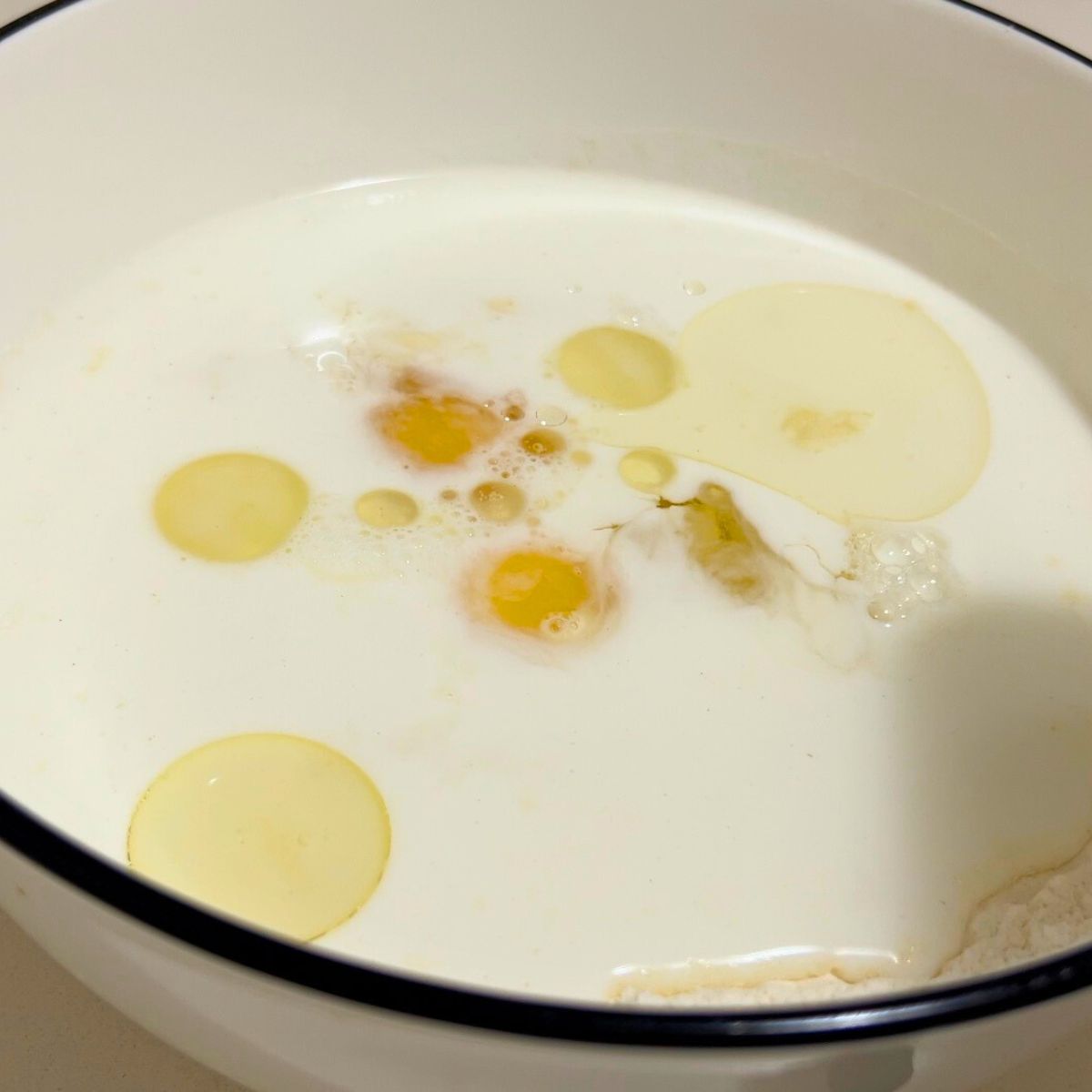 A white bowl with pumpkin batter.