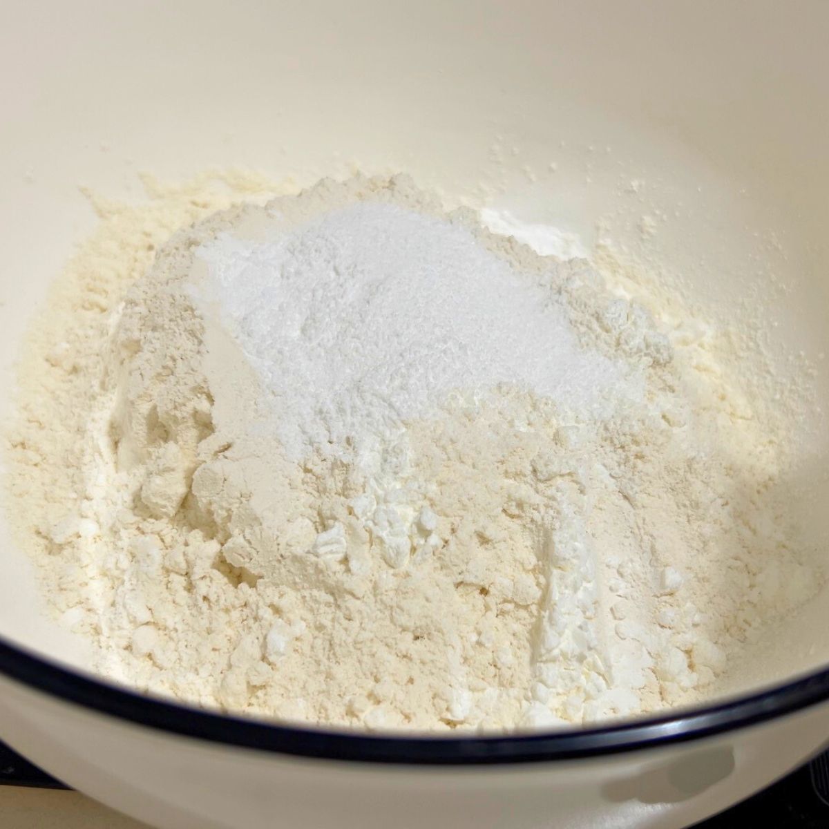 Dry ingredients in a white bowl for pancake batter.