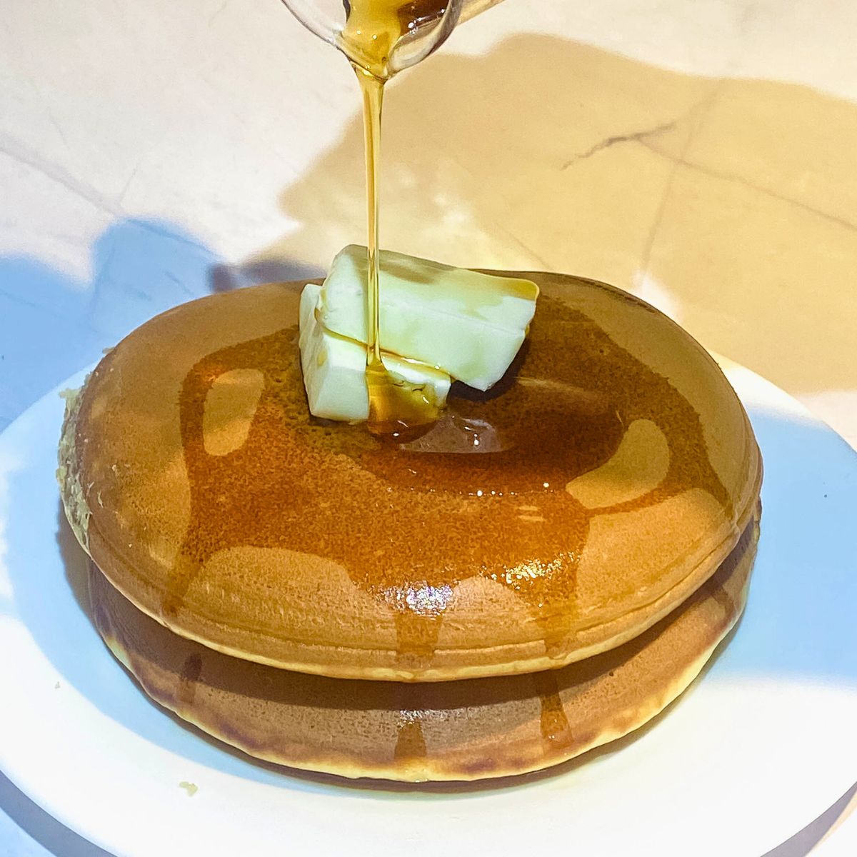 Two fat pancakes with maple and butter.