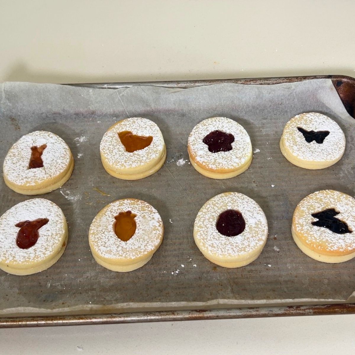 Baking tray with fresh jam sandwich cookies for Easter.