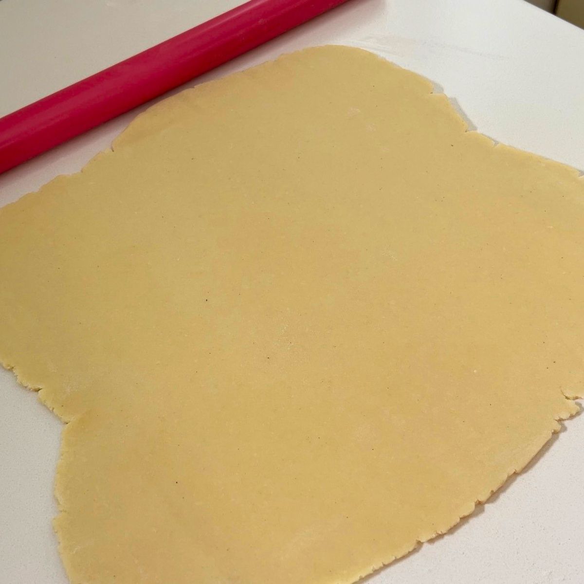 Cookies dough rolled to cut out shapes.
