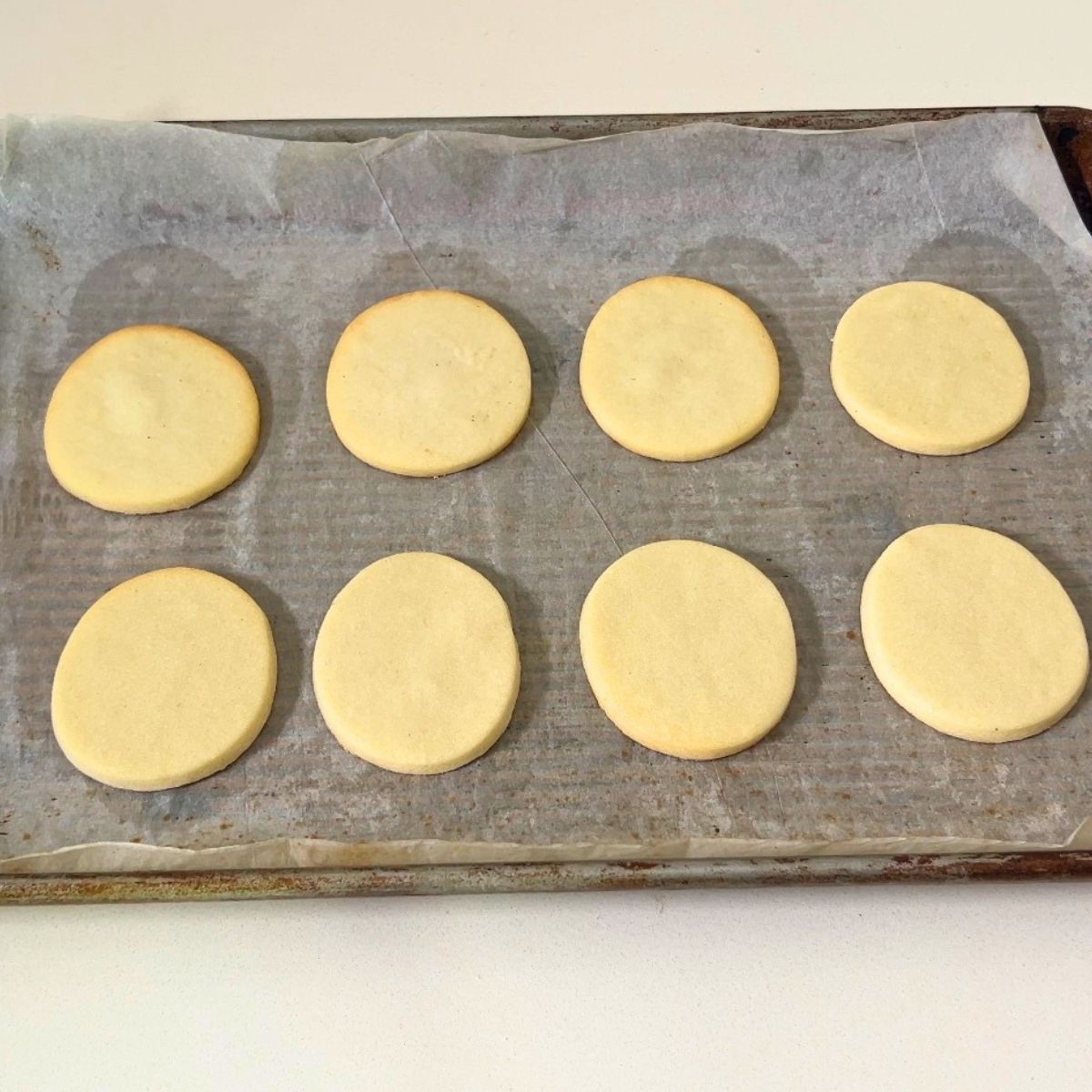 Baked egg shaped cookies on the tray.