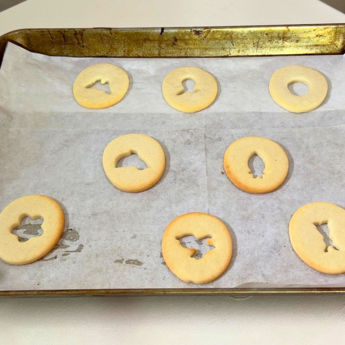 Top cookies for sandwich cookies fresh baked on the baking tray.