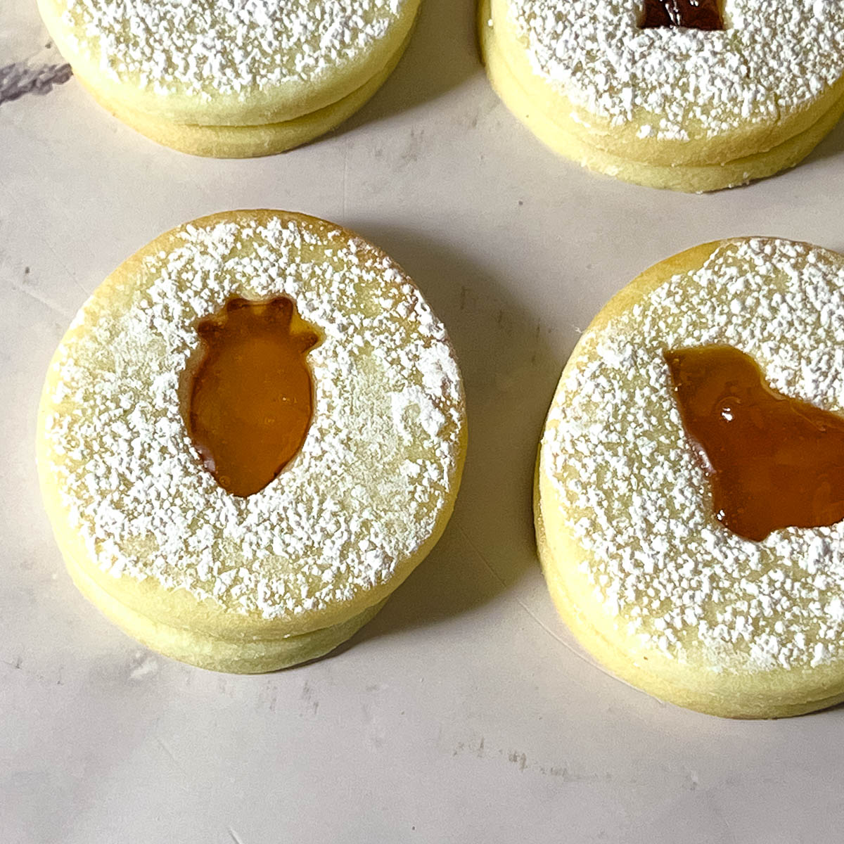 Carrot cut out cookie with apricot jam on the table.