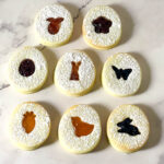 Sandwich cookies with Easter shape cut out on the table.