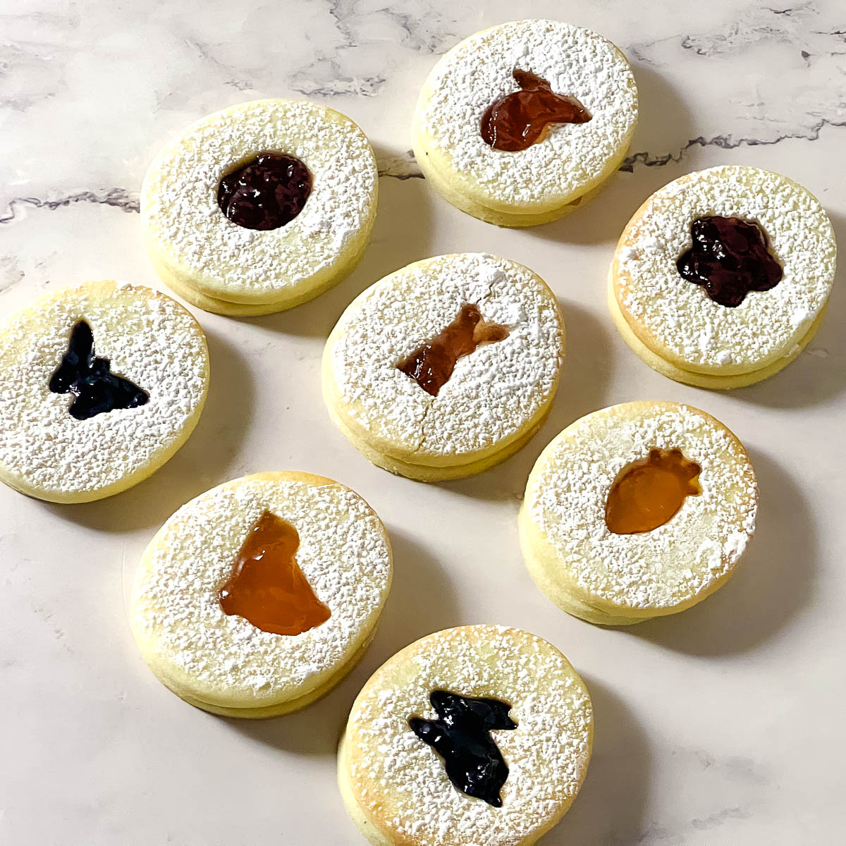 Sandwich cookies with jam for Easter on the table.