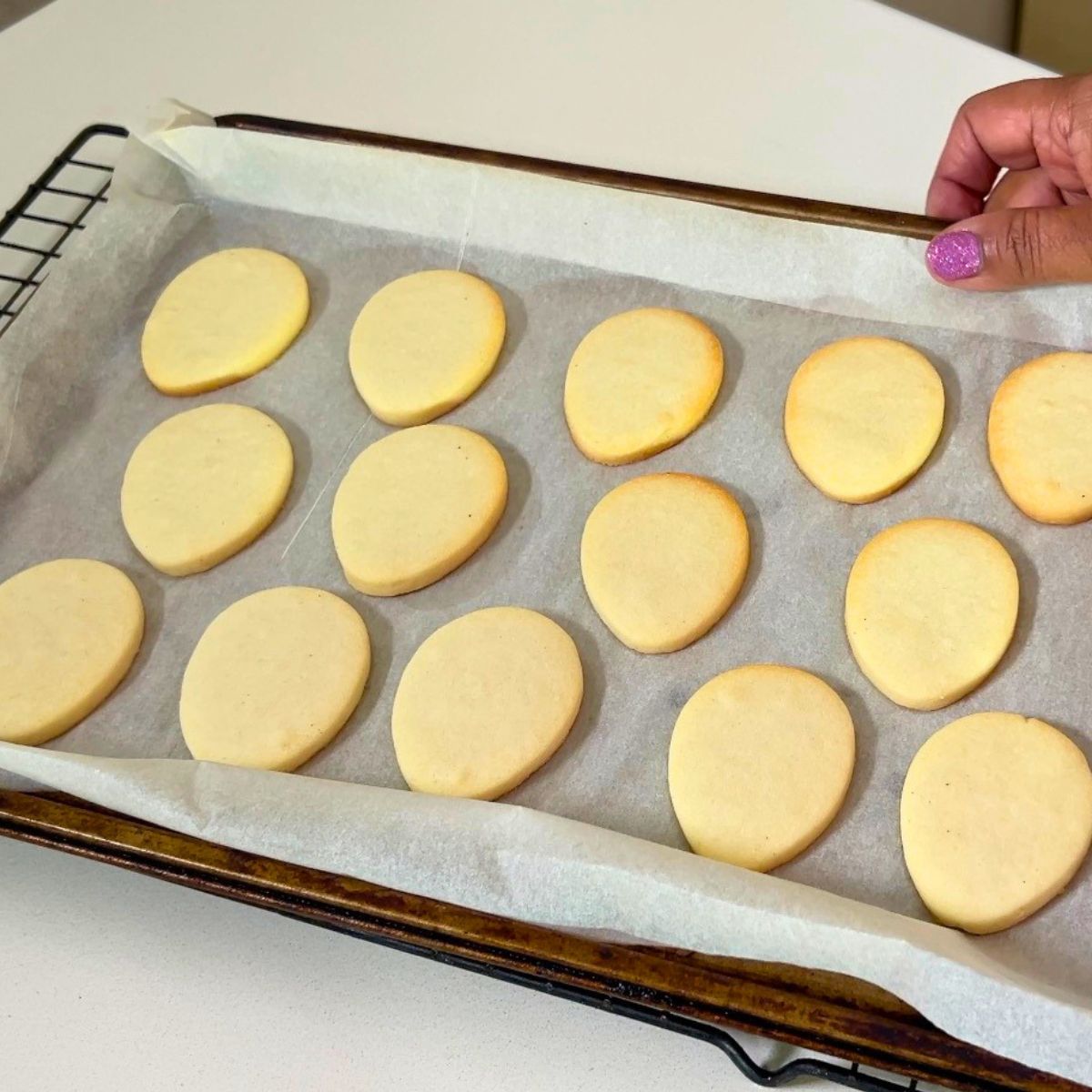 Baked Egg shaped cookies on the tray.