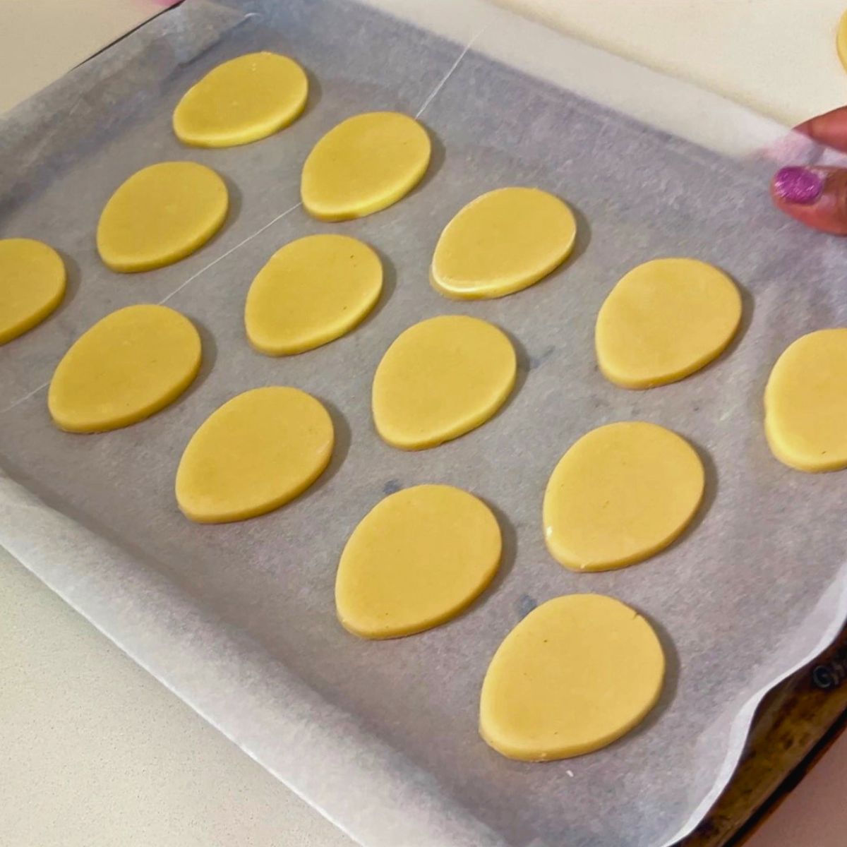 Egg-shaped cookies are ready for baking.