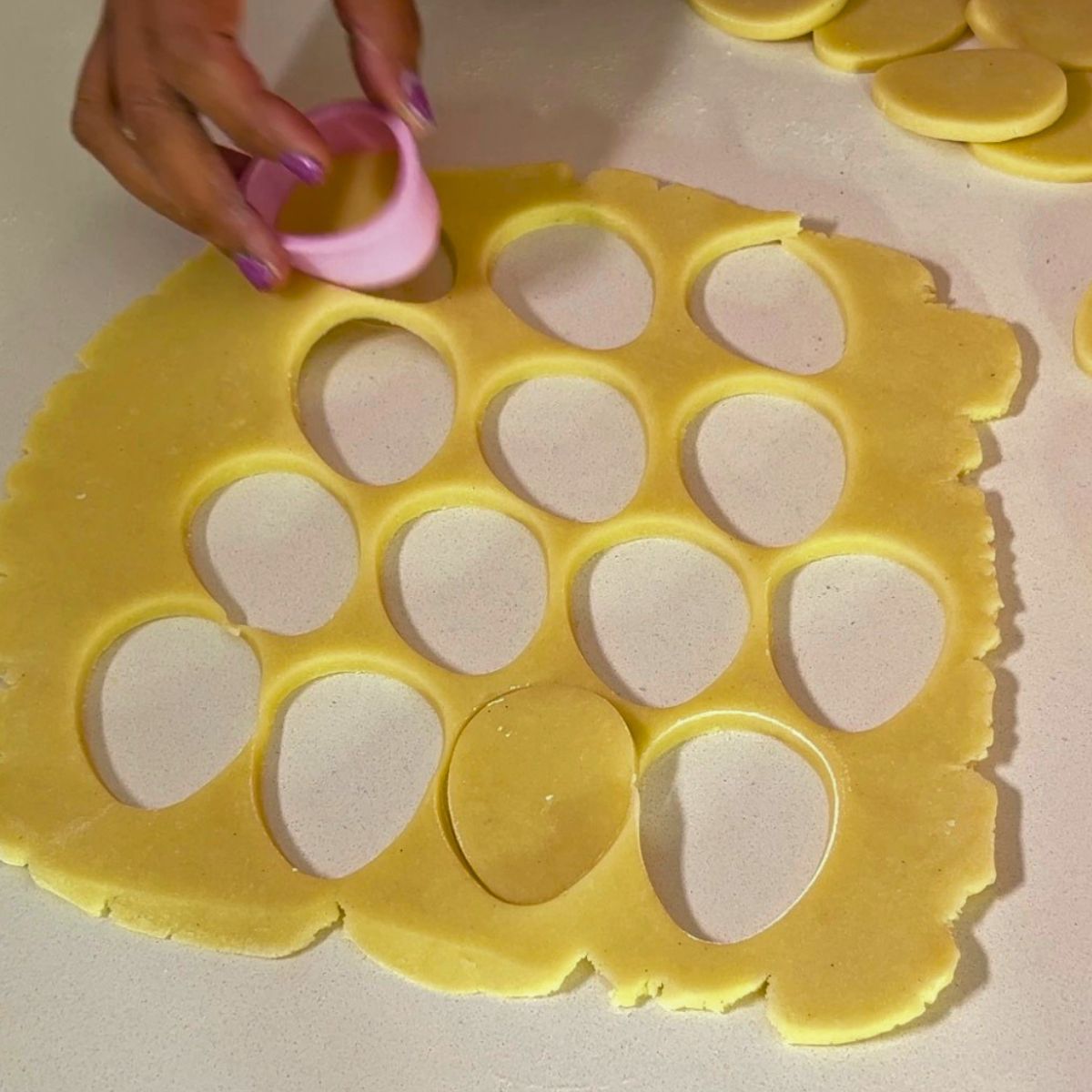 Using egg-shaped cookie cut-out cookies.