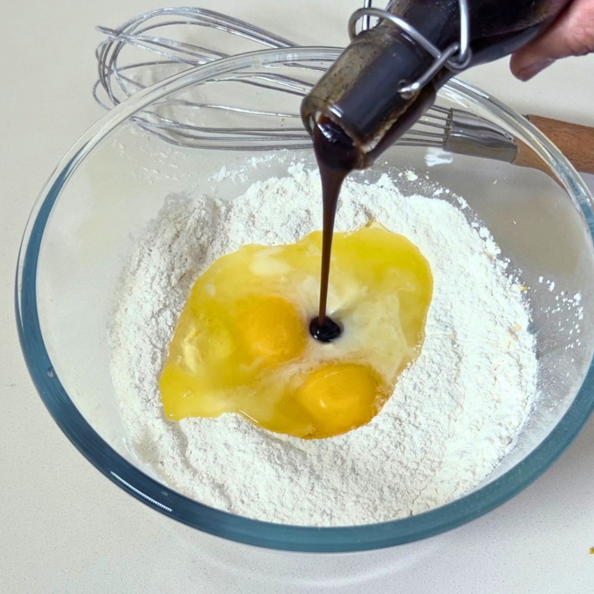 Making pancake batter in a glass bowl.