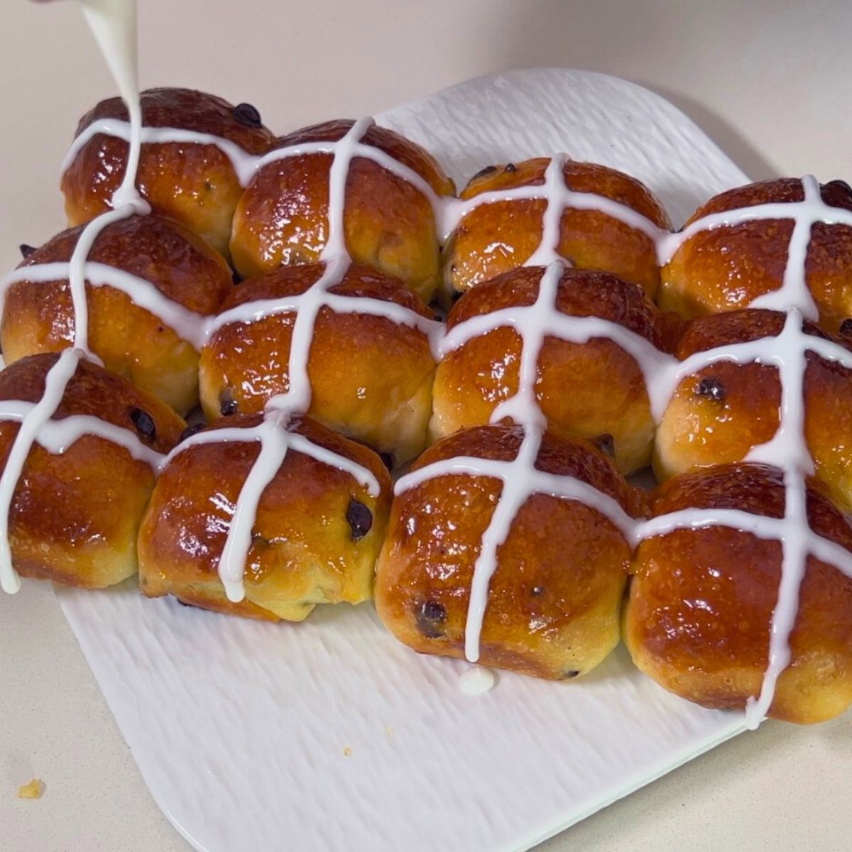 Piping Icing Cross on Hot Cross buns.