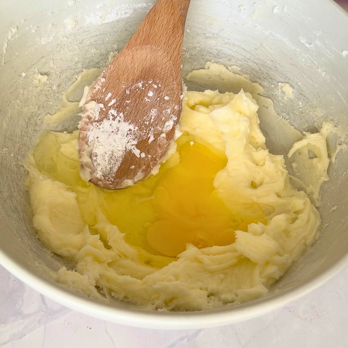 A bowl with butter, sugar powdered with egg for cookie dough.
