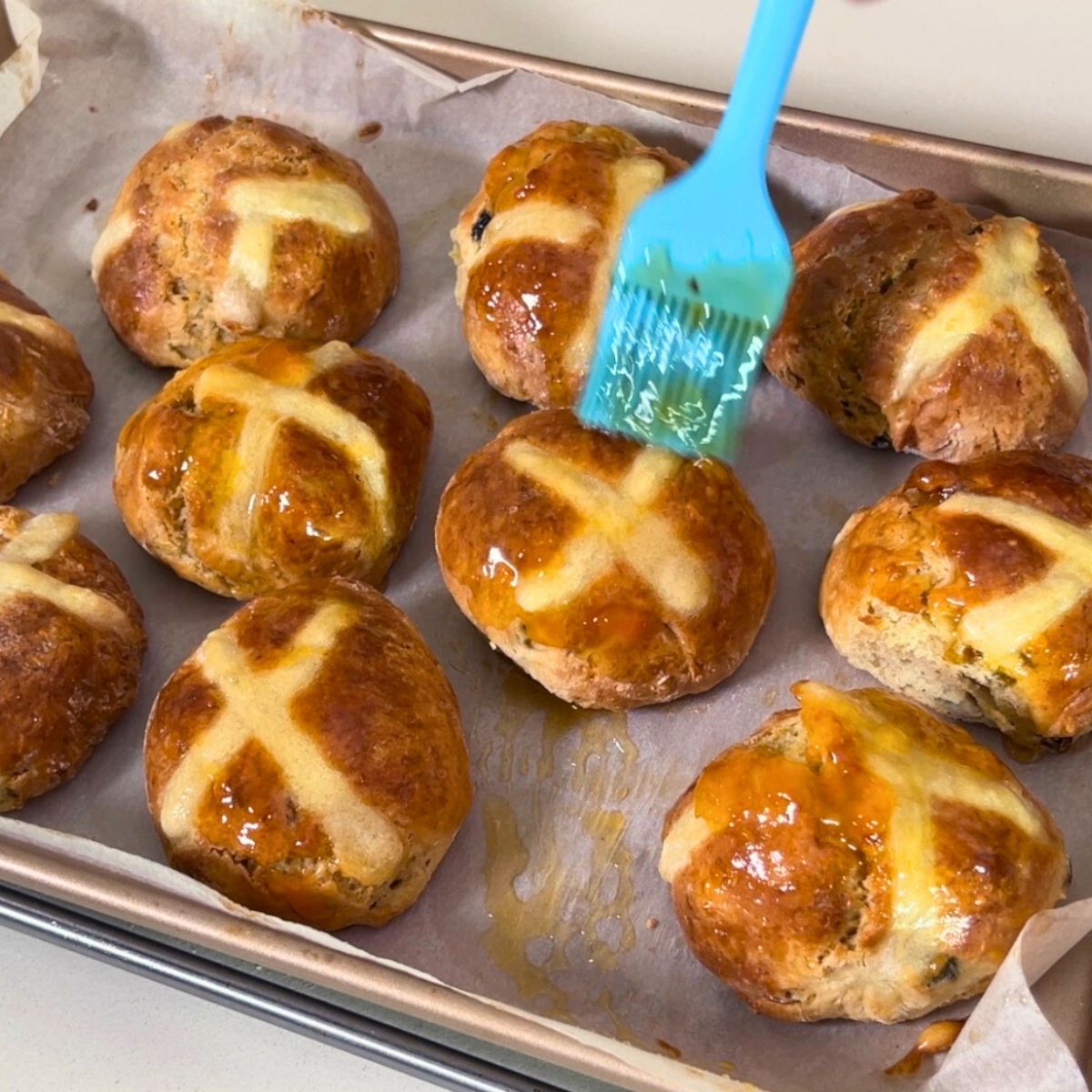 Brush jam on hot cross buns.