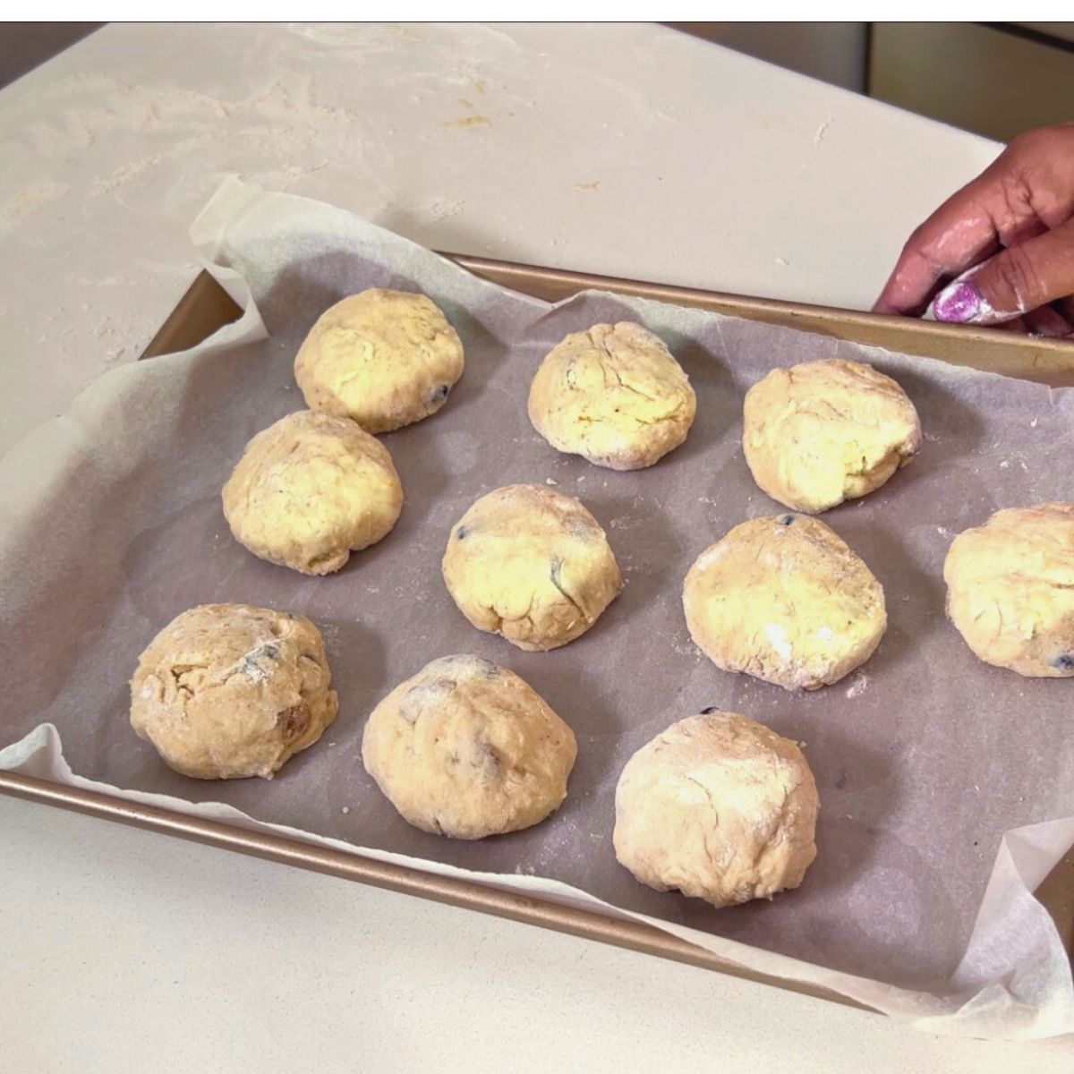 A baking tray with shaped hot cross buns.