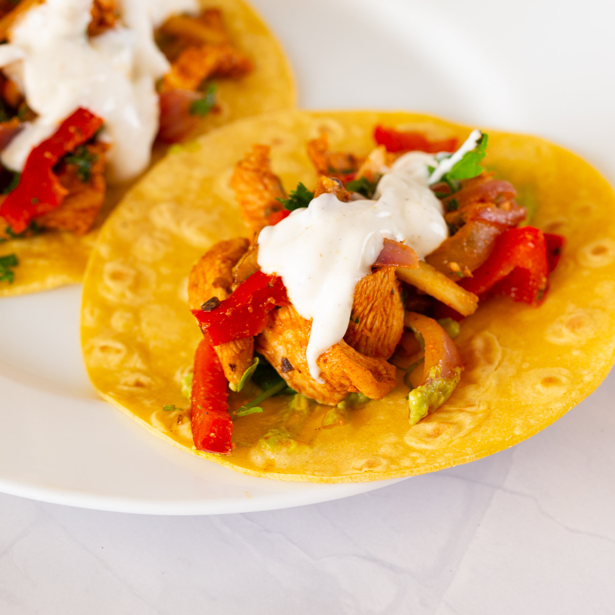A place with chicken taco on tortilla.