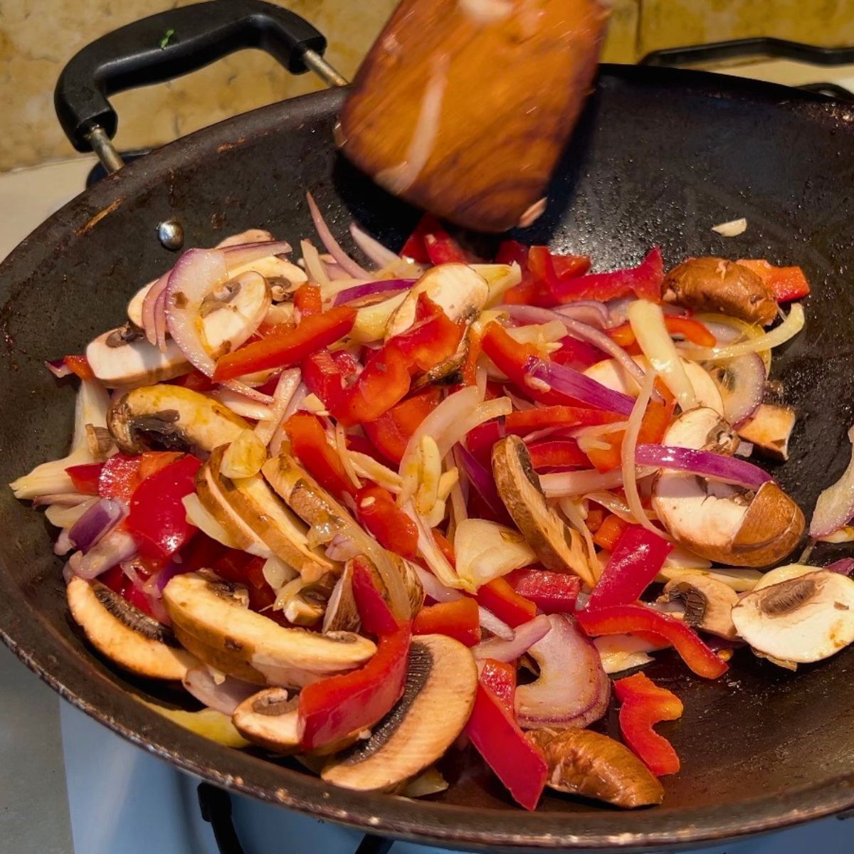 A skillet with veggies sauteed for taco.