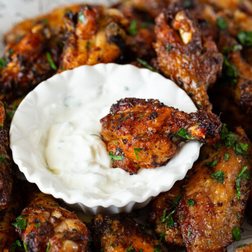 Lemon butter wings on a pile on newspaper.