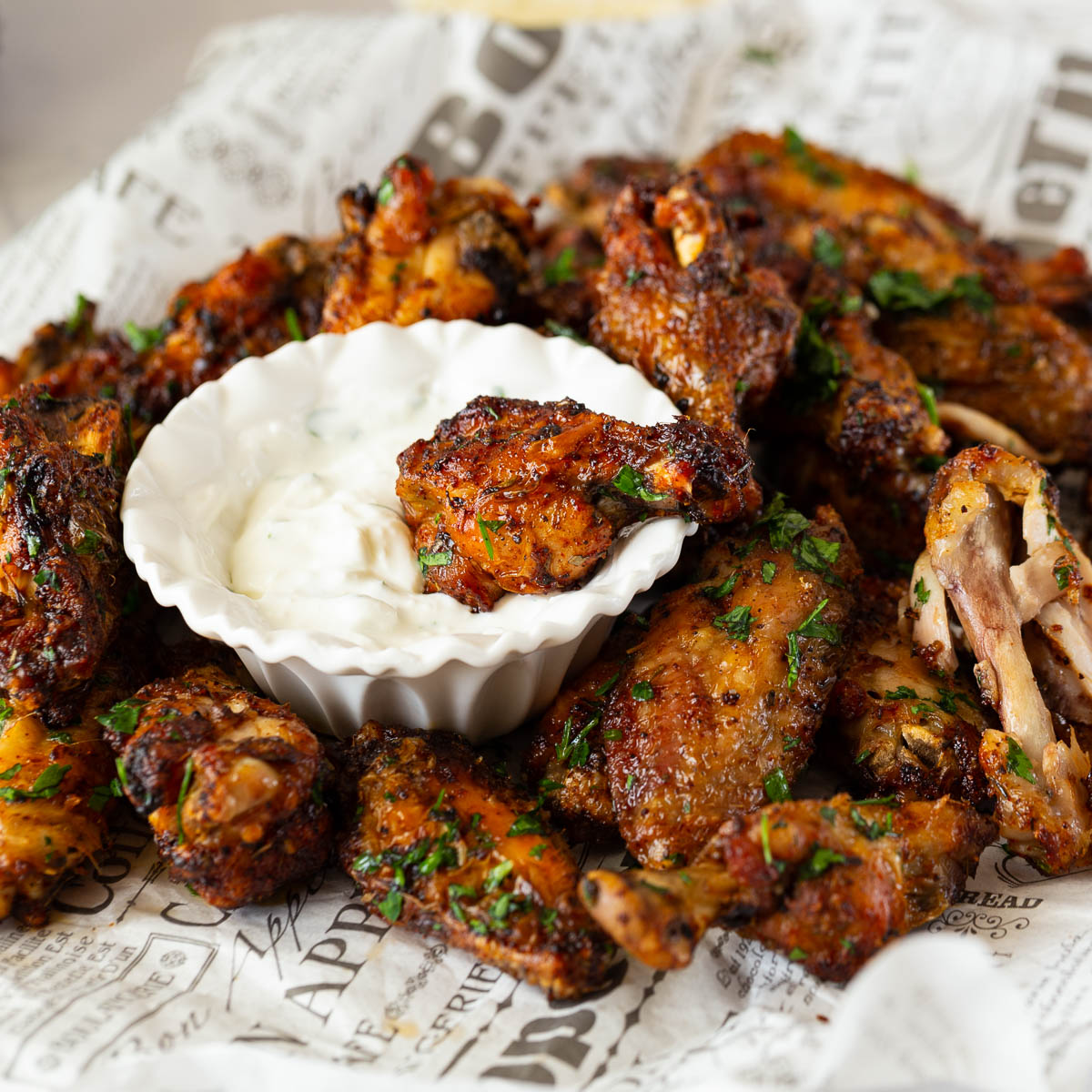 A newspaper with pie of chicken wings.