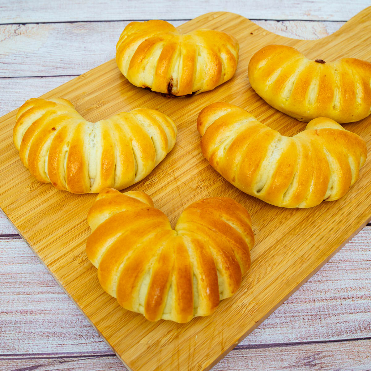 Crescent shaped buns with Nutella on the table.