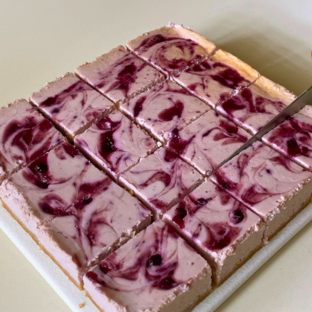 Blueberry swirl cream cheese bars on the table.