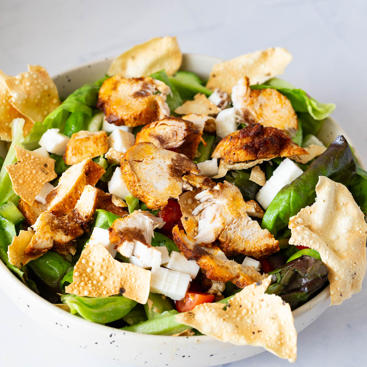 A bowl with Butter Lettuce Chicken Salad.