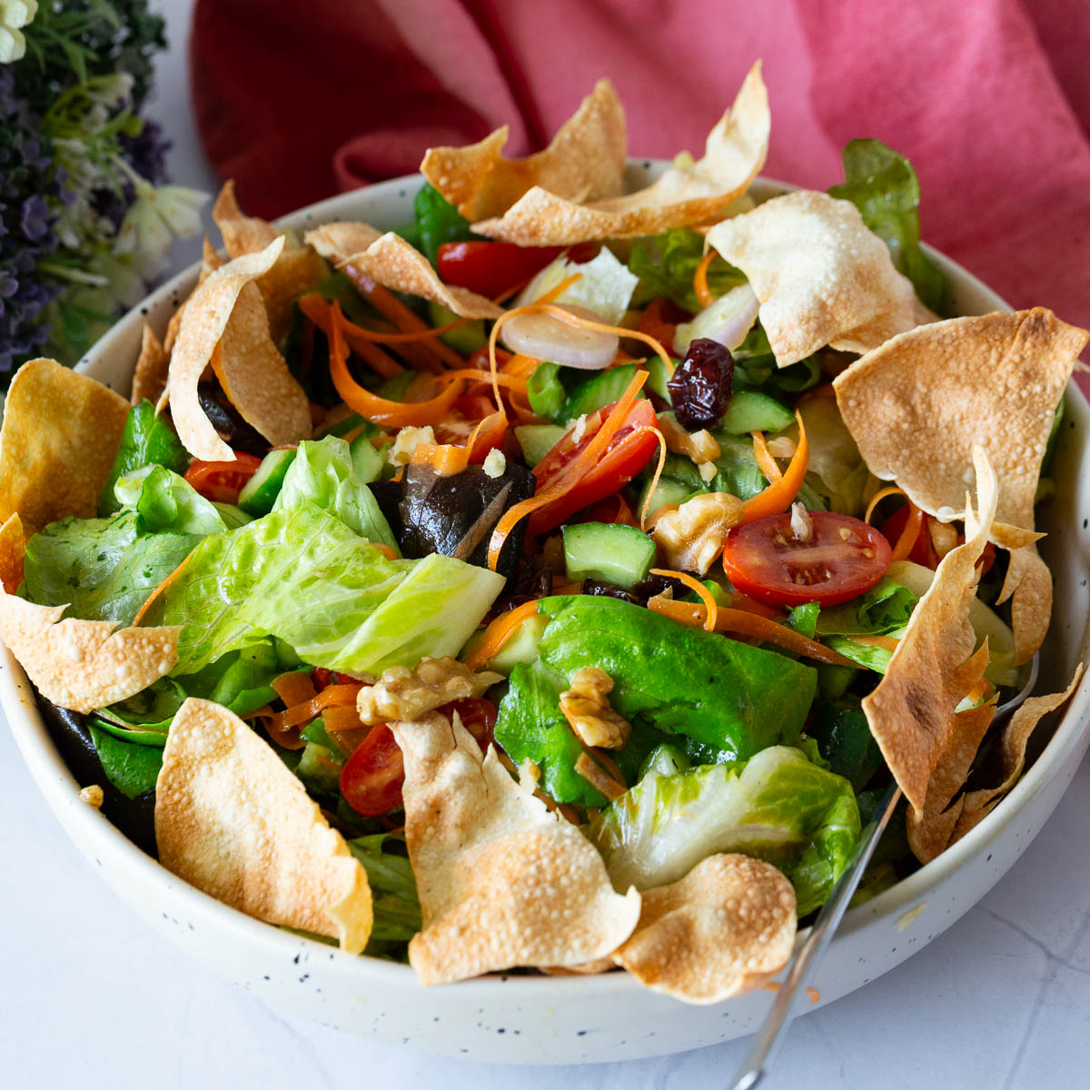 A bowl with fresh butter lettuce salad and veggies.