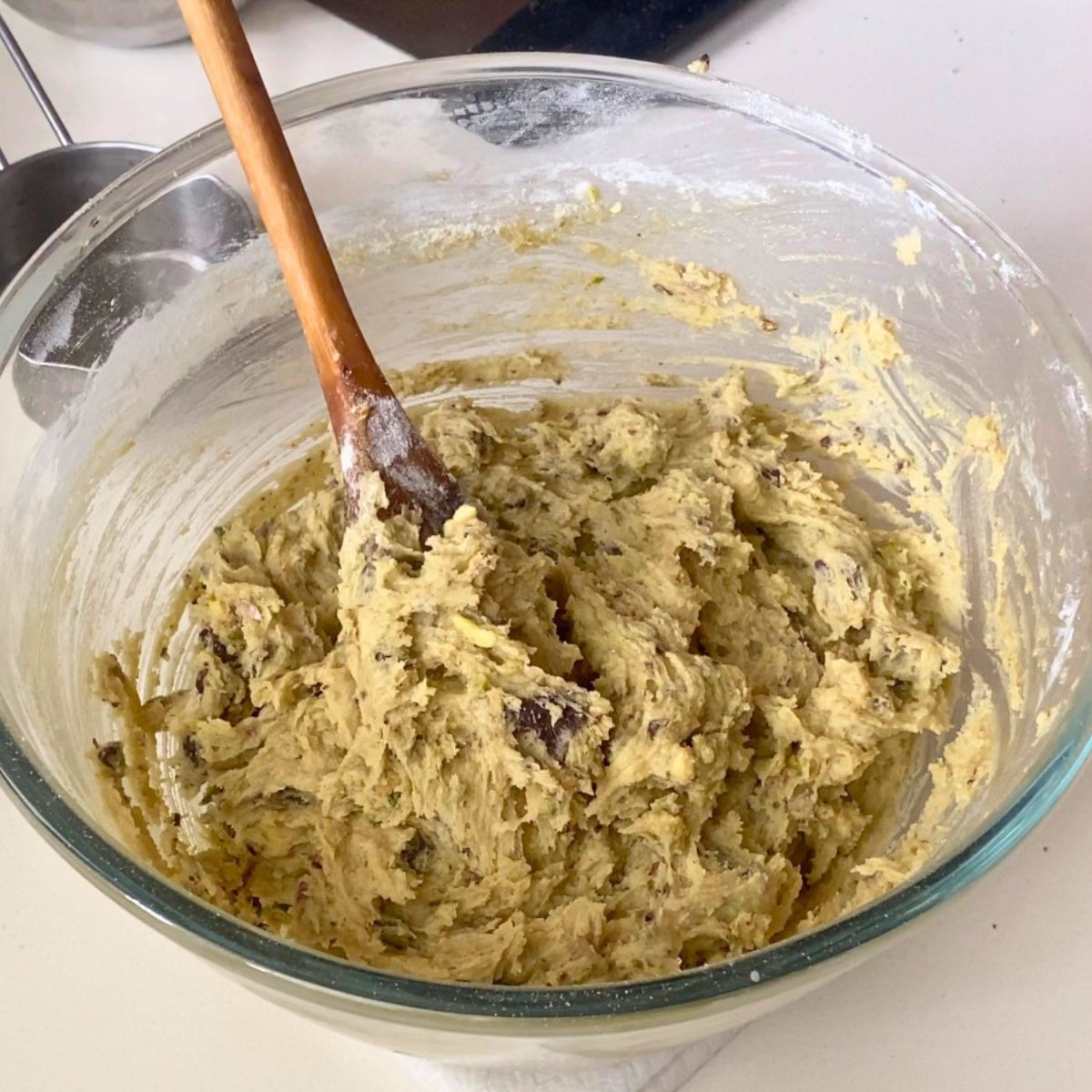 A glass bowl with pistachio cookies.