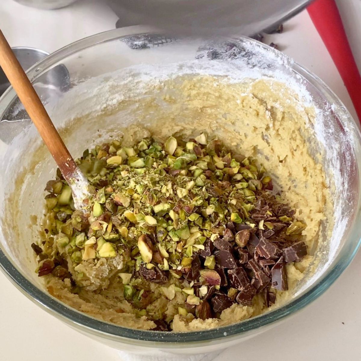 A glass bowl with chocolate chip pistachio cookie dough.