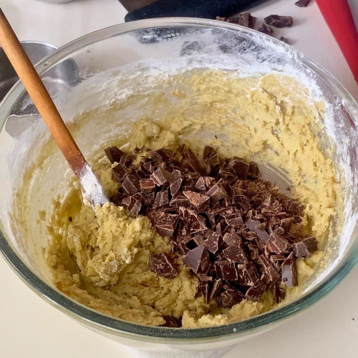 Adding chocolate chips to the pistachio cookie dough.