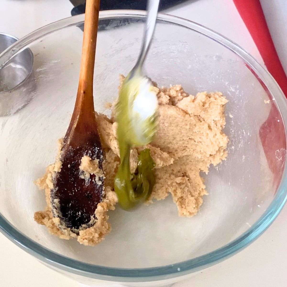 Glass bowl with pistachio paste in cookie dough.