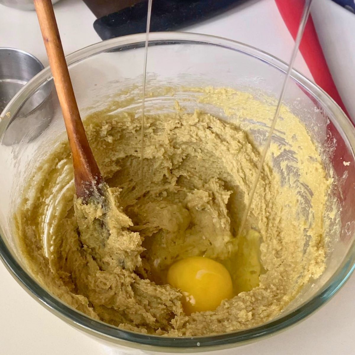 Making pistachio cookie dough in glass bowl.