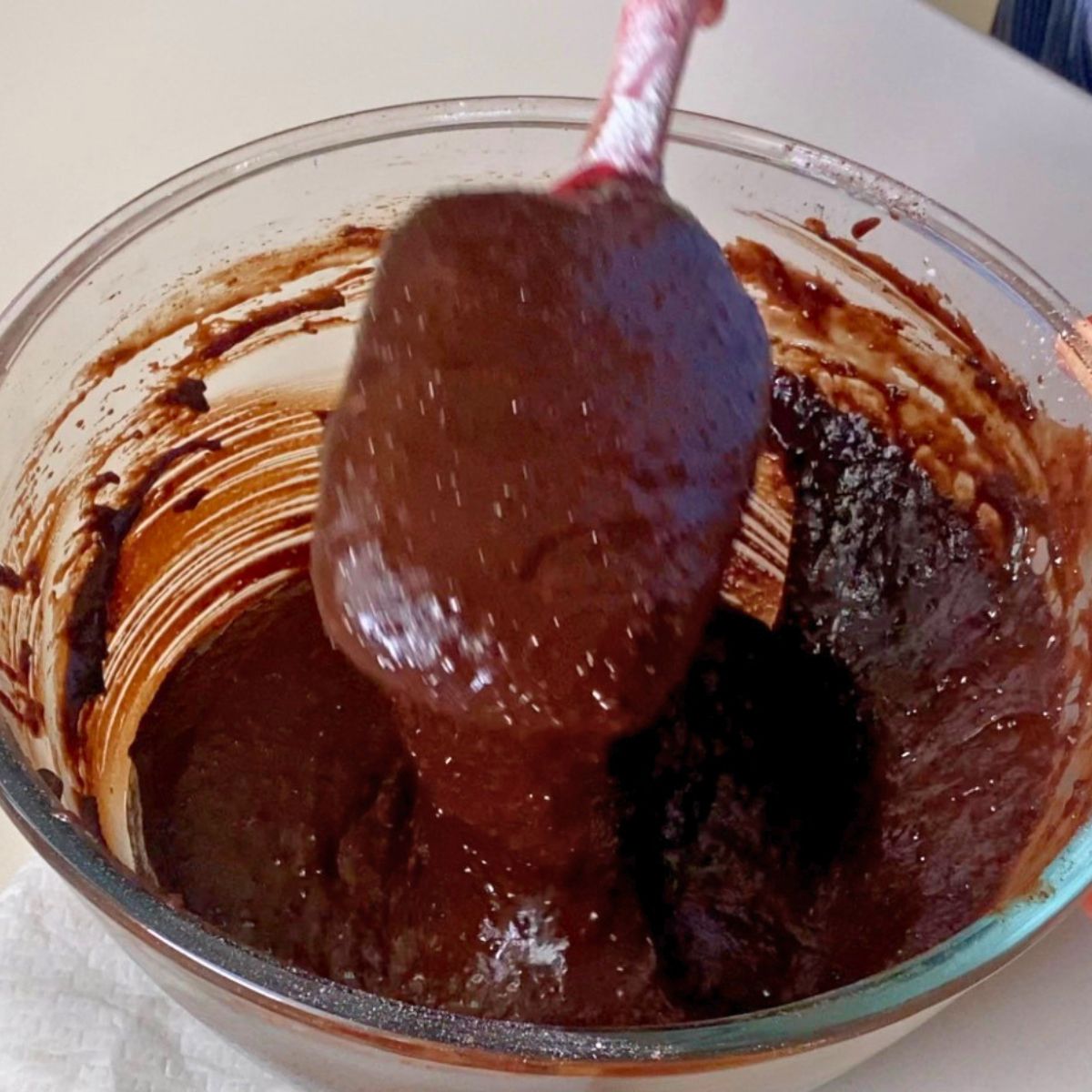 Chocolate mousse batter in a glass bowl.