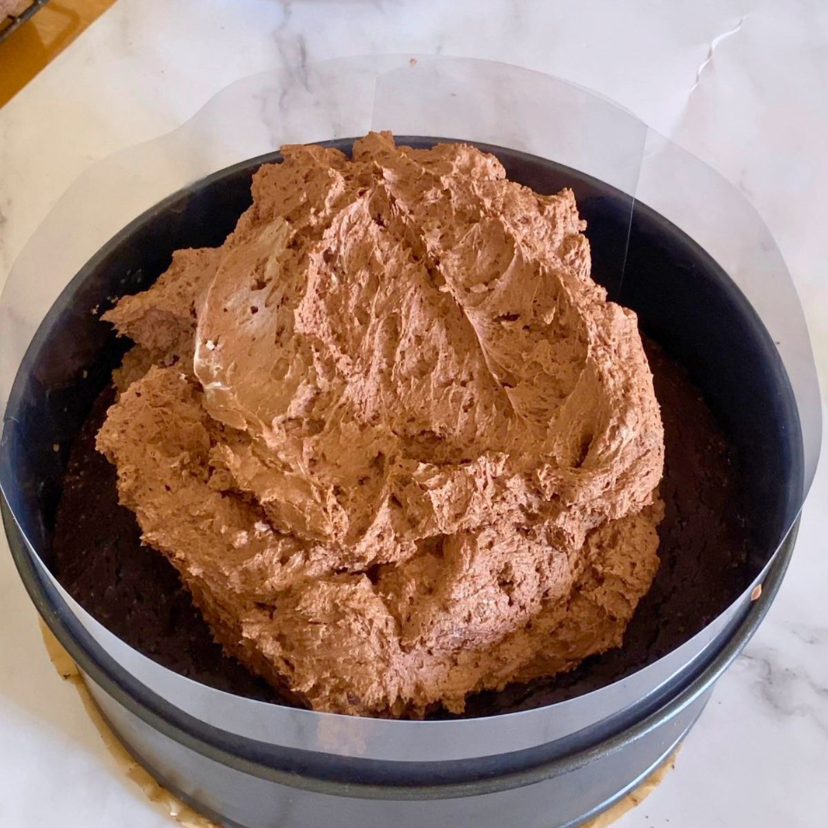 A spring form pan with chocolate mousse.