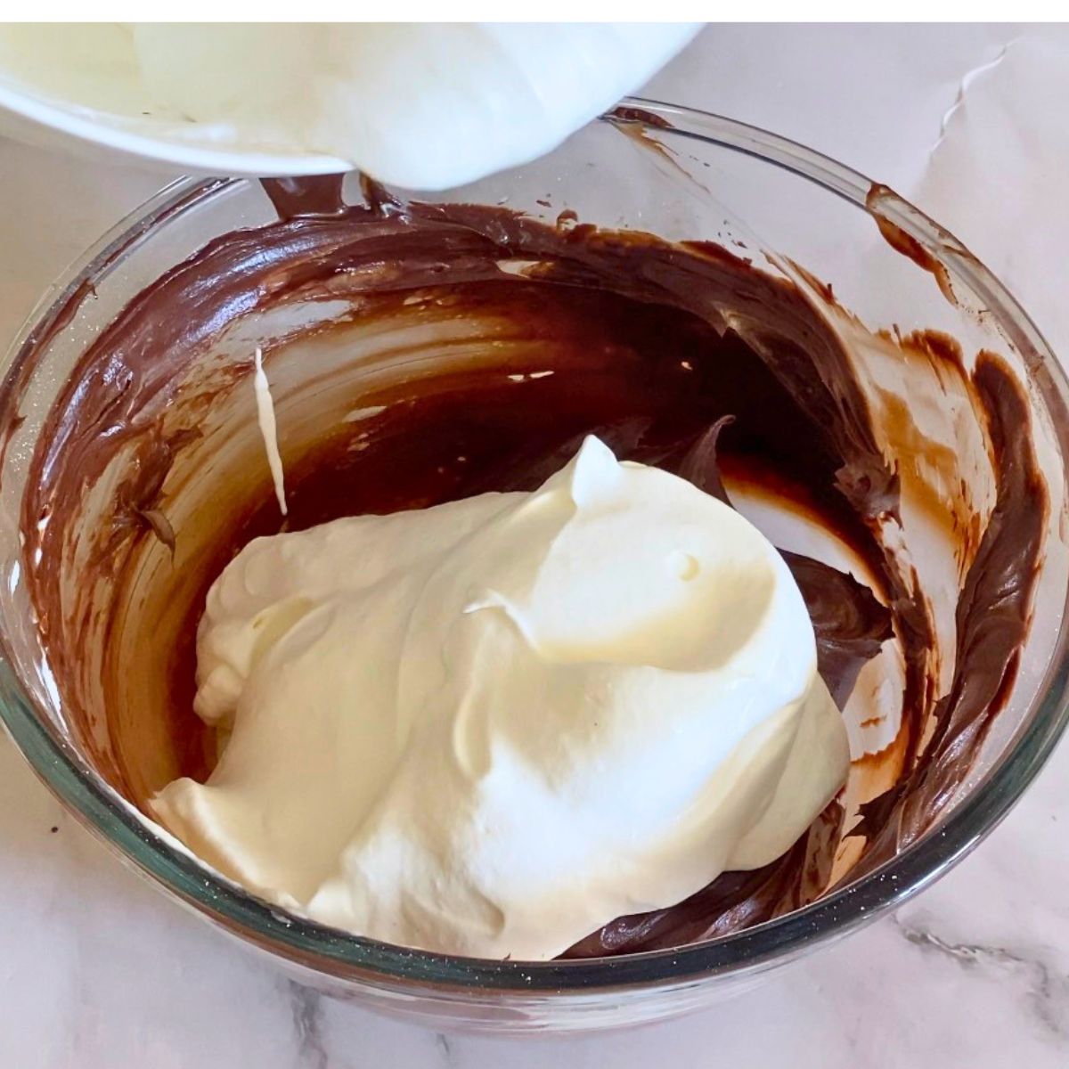 Adding heavy cream to the chocolate cream cheese batter.