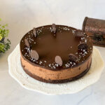 A chocolate mousse cake on the cake stand.