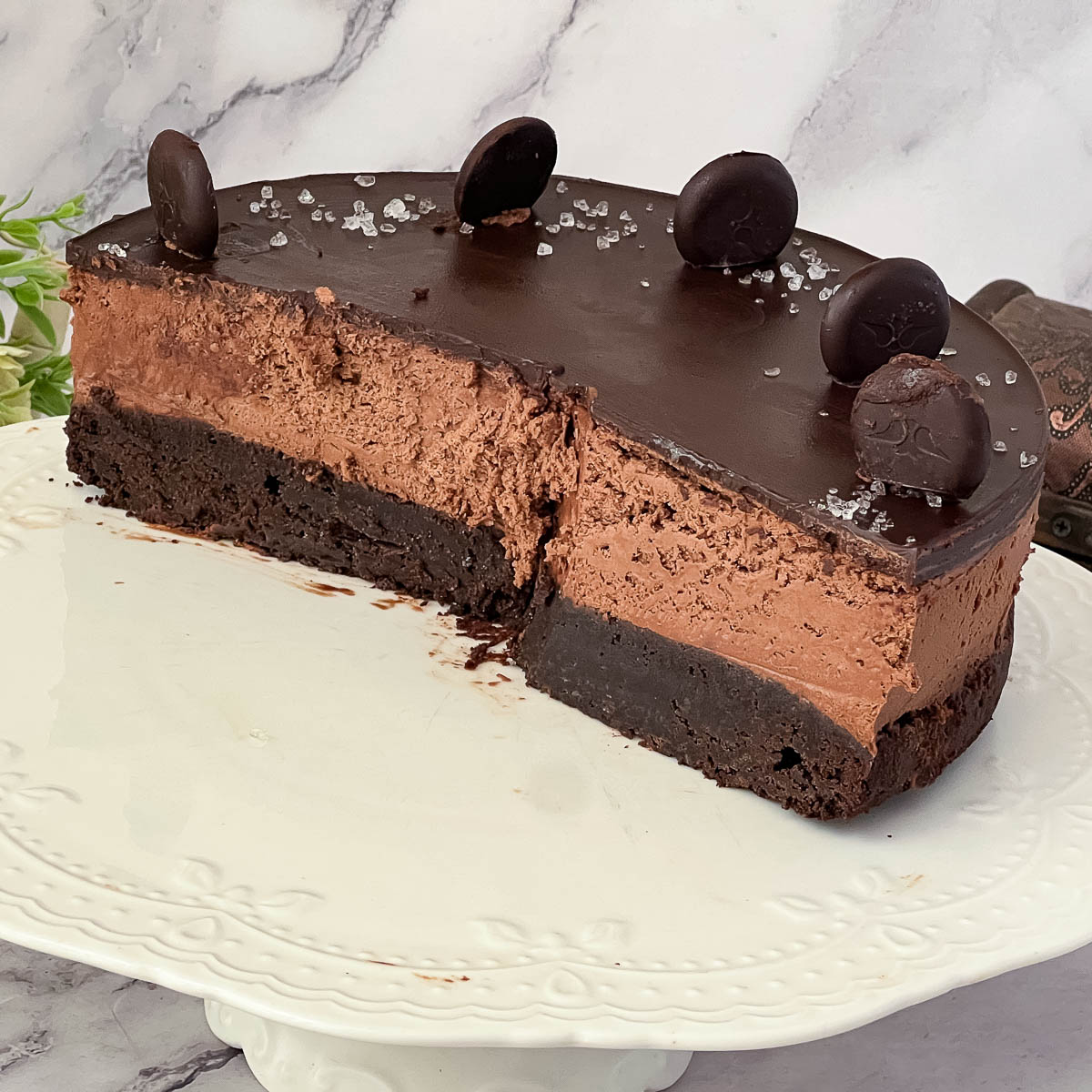 Half chocolate mousse cake on the table.