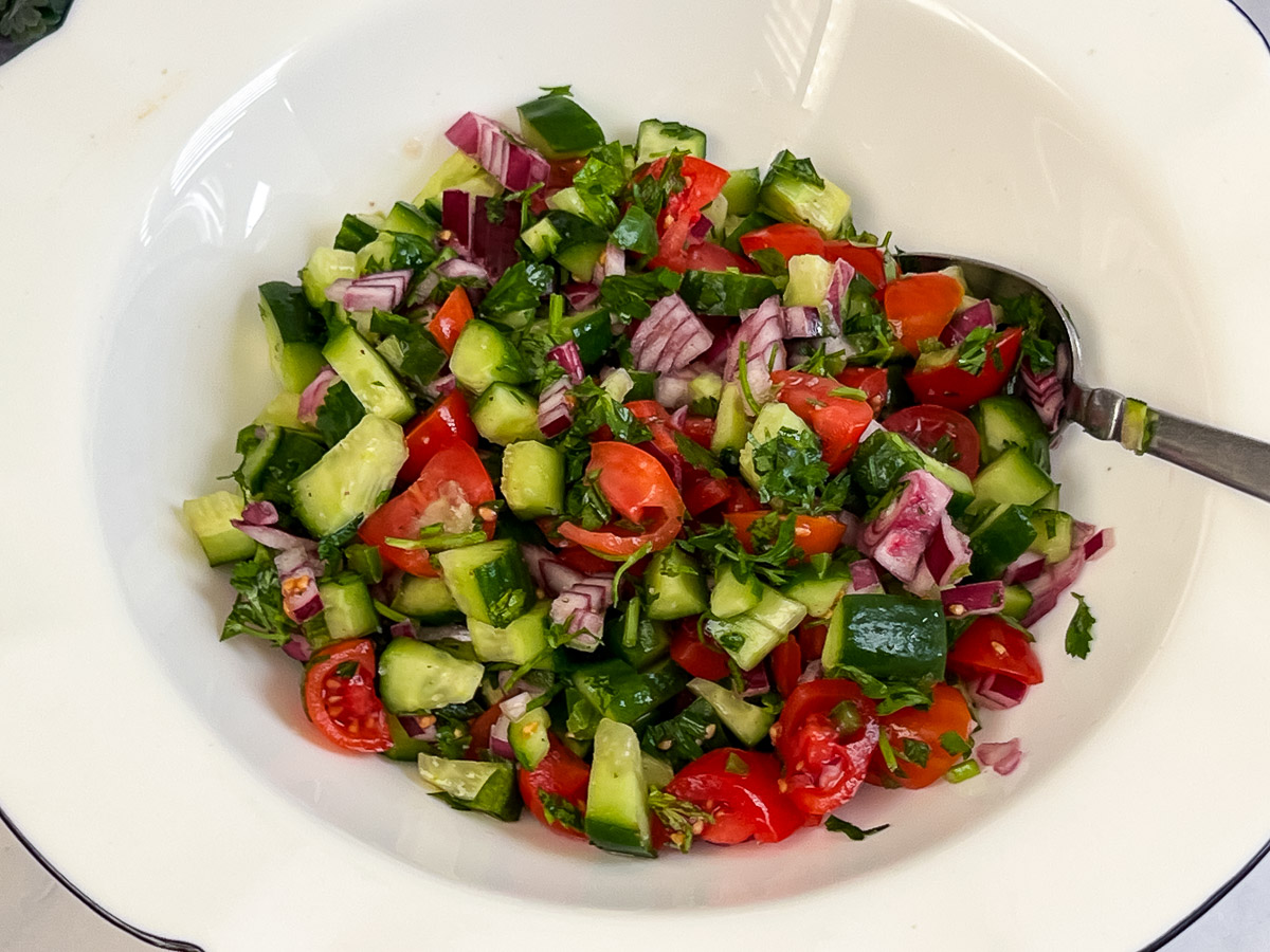 Salad in a white bowl.
