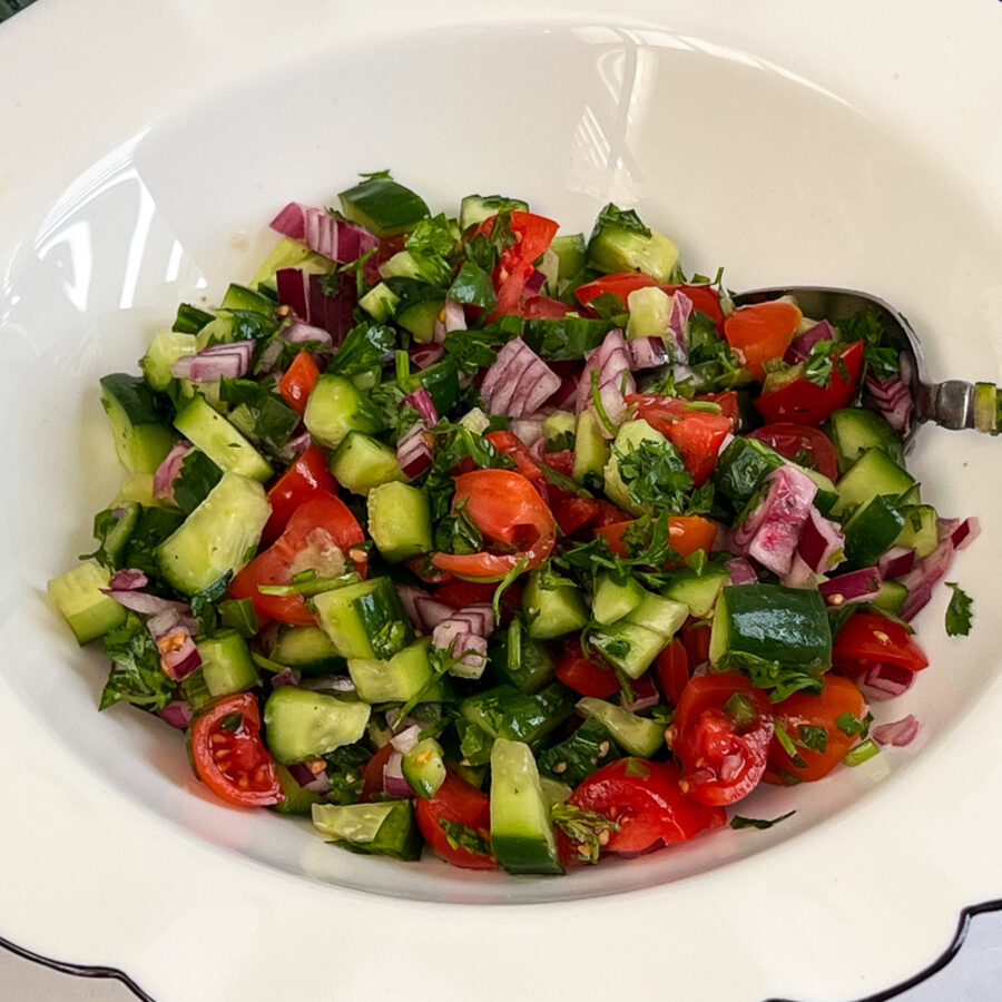 A white bowl with chopped Israeli Salad.