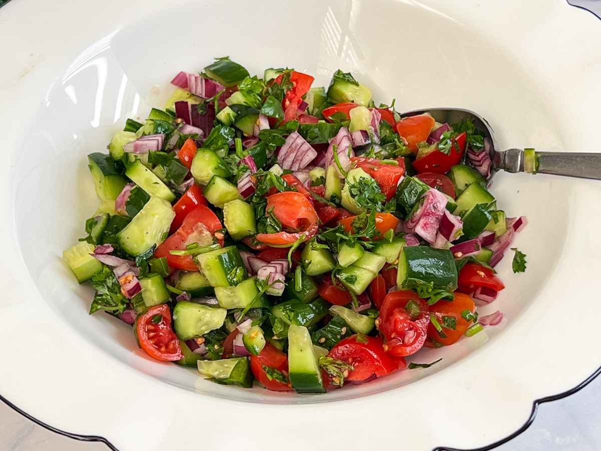 A white bowl with chopped salad.