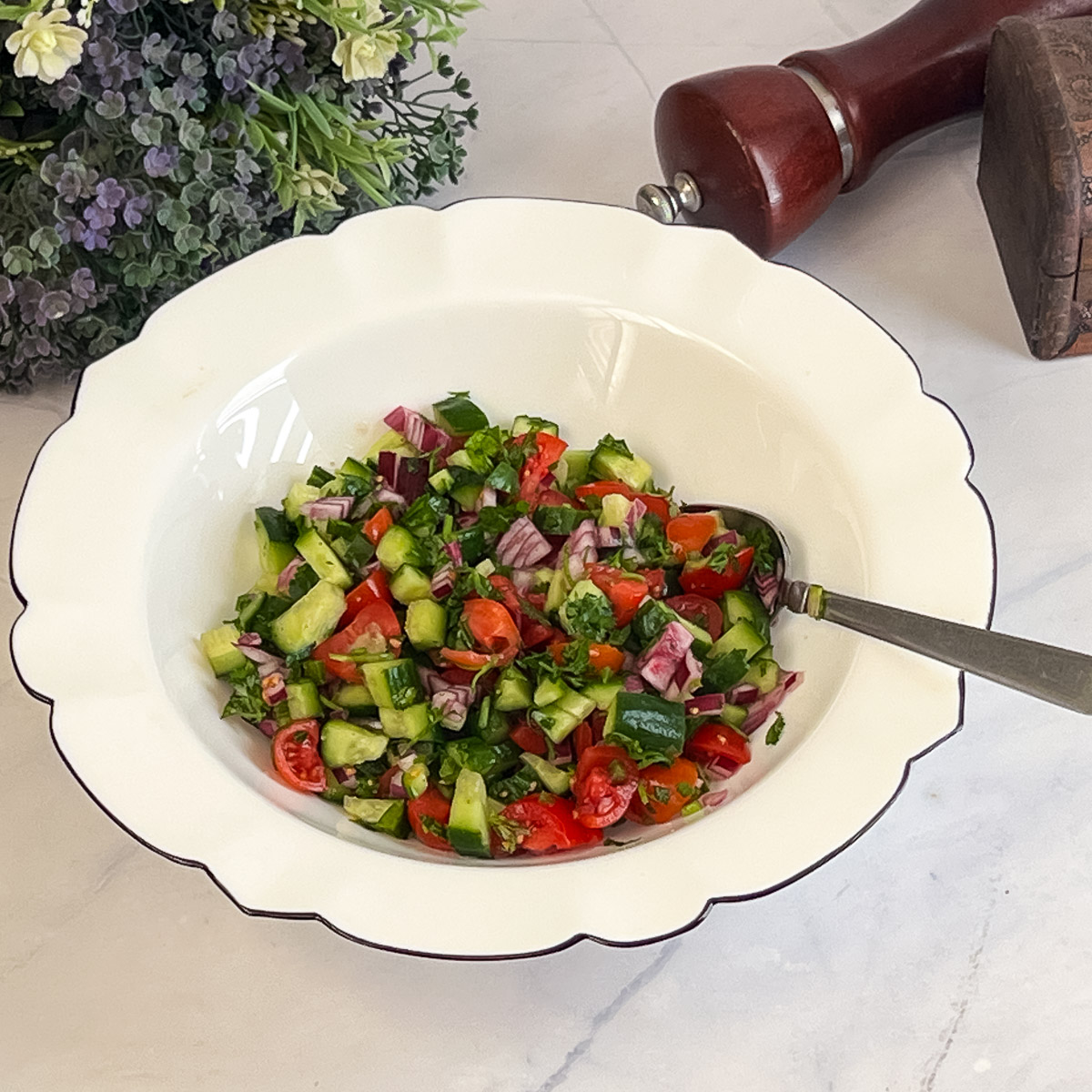 A white bowl with chopped salad.