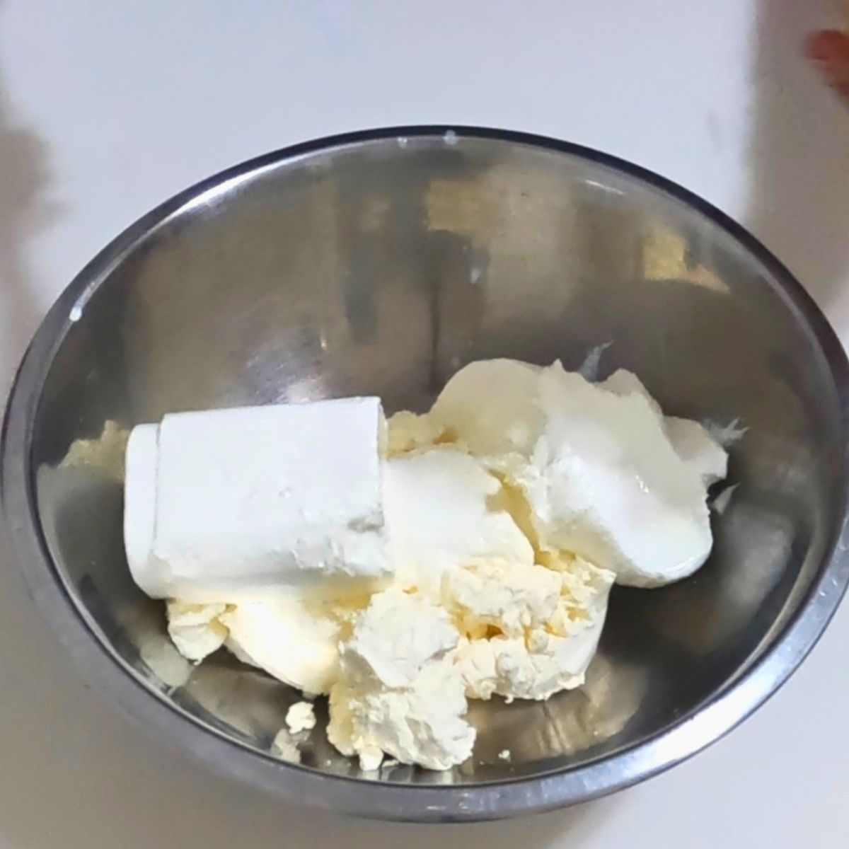 A bowl with cream cheese, sour cream and heavy cream.