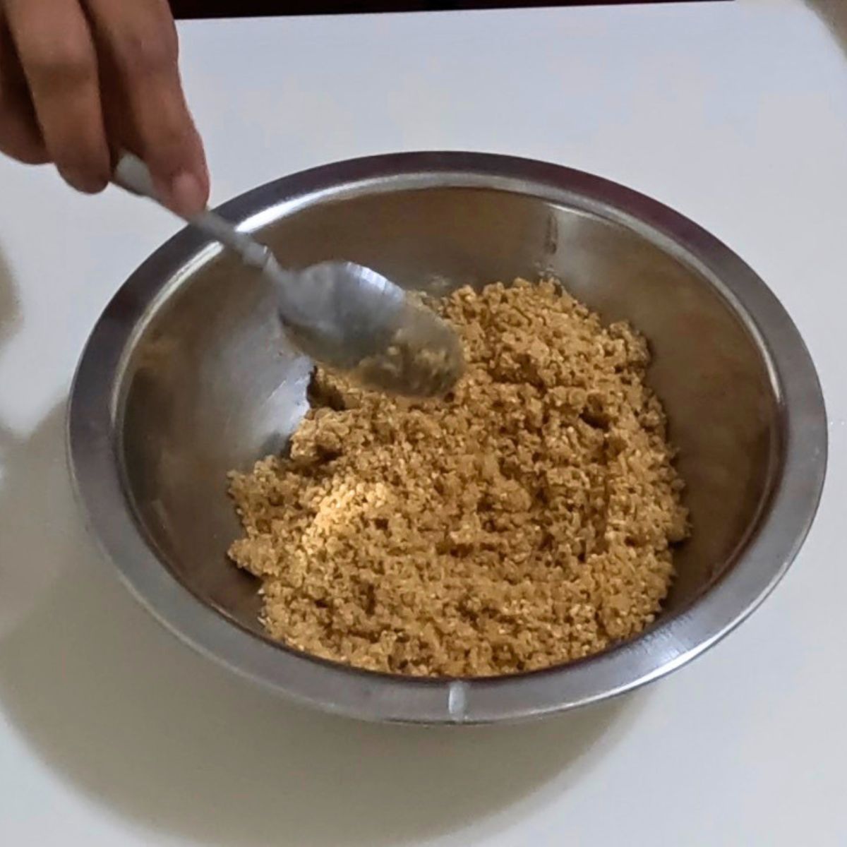 A bowl with cracker crumbs and butter.