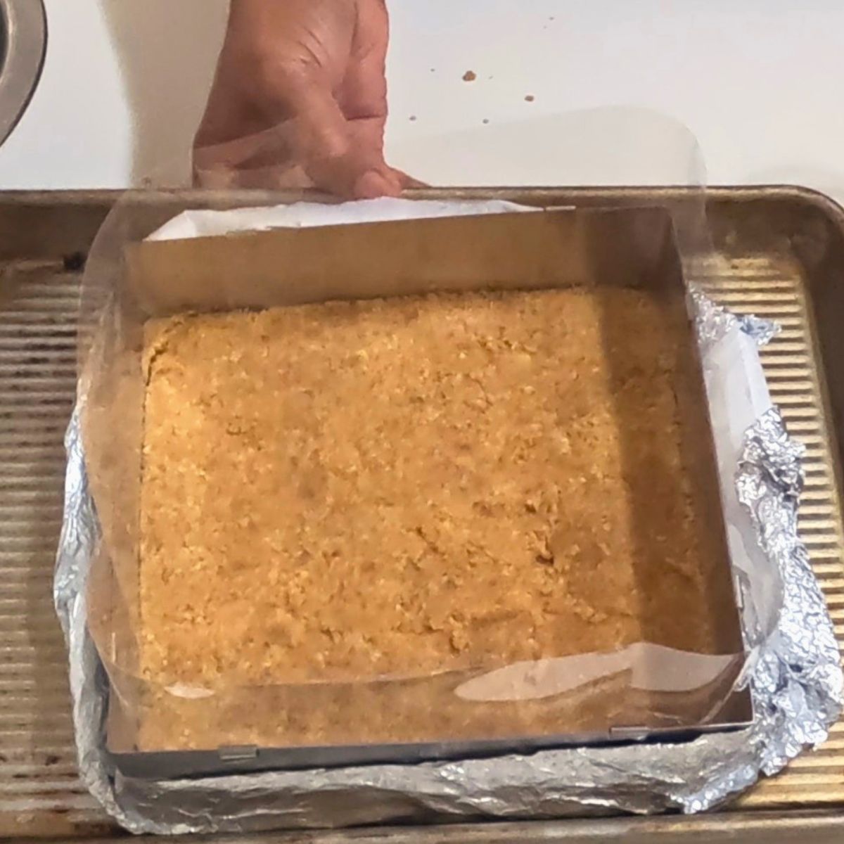 A square baking pan with cookie crust.