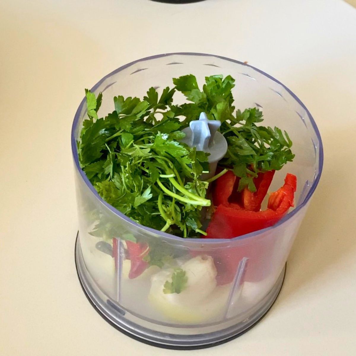 Food processor with veggies for kebabs.