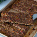 A sheet pan with baked kebabs.
