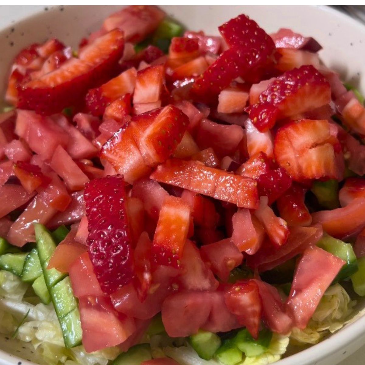 Add chopped strawberries to the bowl.