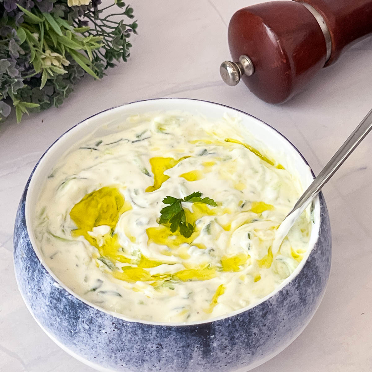 A bowl with Greek yogurt Tzatziki.