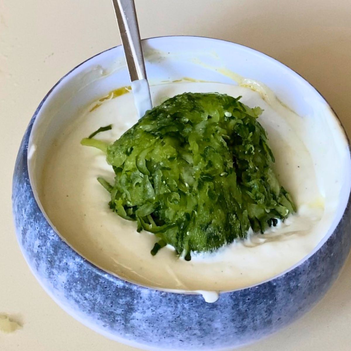Squeezed cucumber in Greek yogurt for Tzatziki.